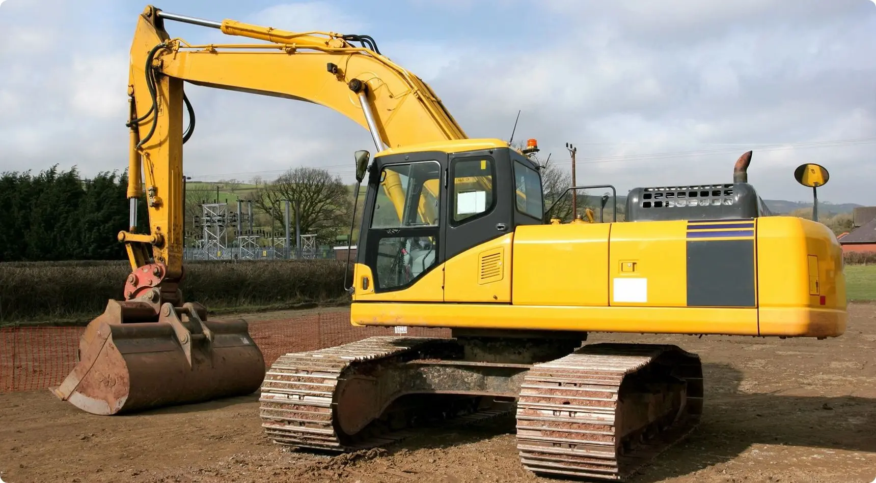 A yellow and black excavator is parked on the ground